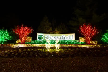 Holiday Lights in front of Greenfield Entrance sign with two reindeer