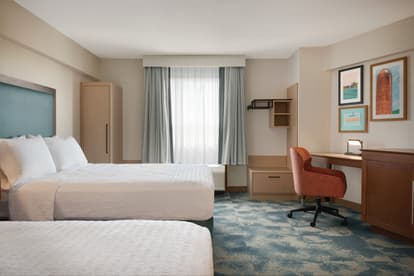 Photo of updated room with two queen beds 