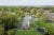 Aerial view of Greenfield properties and pond 