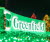 Greenfield Entrance sign illuminated with green holiday lights.