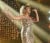 Photo of young adult woman singing on stage in long gold dress 