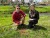 Man and Woman smiling in front of newly planted tree in Greenfield 